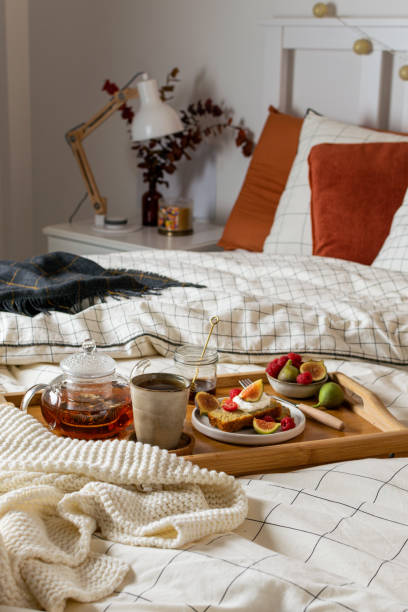 istock Breakfast in bed with pastry and fresh fruits, black tea 1190917644