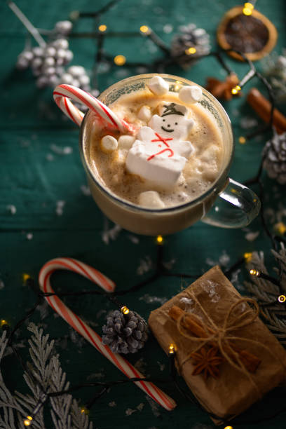 istock Christmas composition. Or happy new year. Vertical frame with a latte mug and a snowman with marshmallows. 1190924356