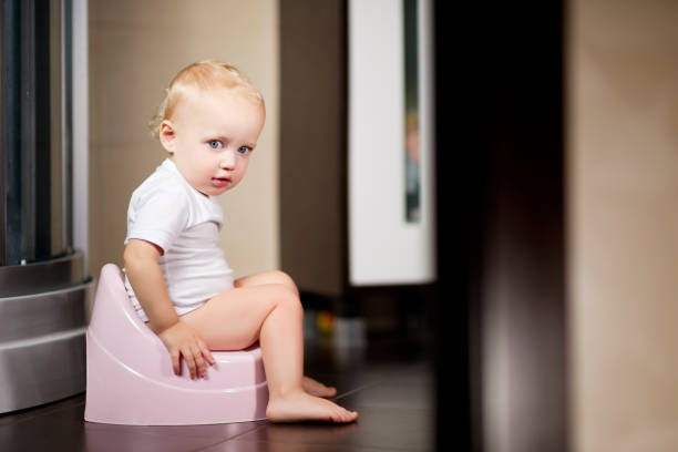 istock Baby girl sits on a pot 1190927673