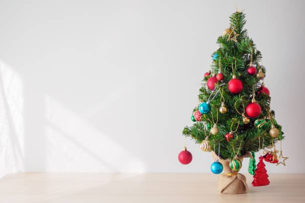 istock Christmas tree on wood table decorated with colorful ball on pine branches background 1190927958