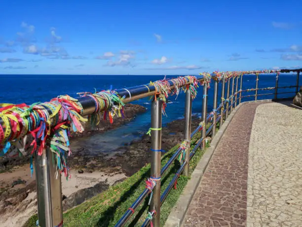 Photo of Senhor do Bonfim colorful ribbons tied in a grid at Barra Lighthouse - Salvador, Bahia