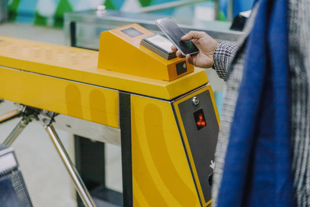istock Young man using smartphone to pay for public transport 1190936593