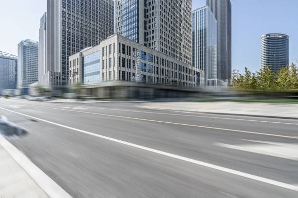 istock blurred asphalt road front of modern buildings 1190938083