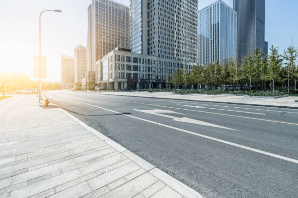 istock empty asphalt road near glass office building 1190938091
