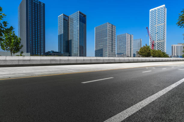 istock city empty traffic road with cityscape in background 1190938299