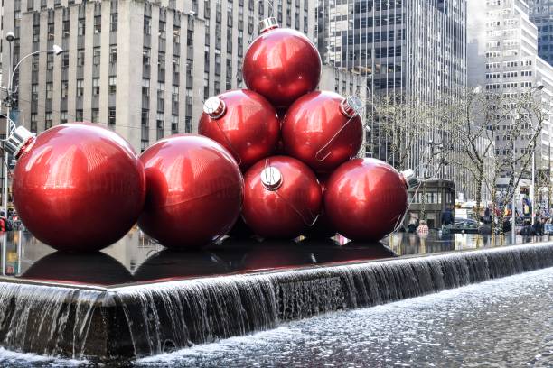 Holiday Ornaments stacked on a fountain in the big city.
