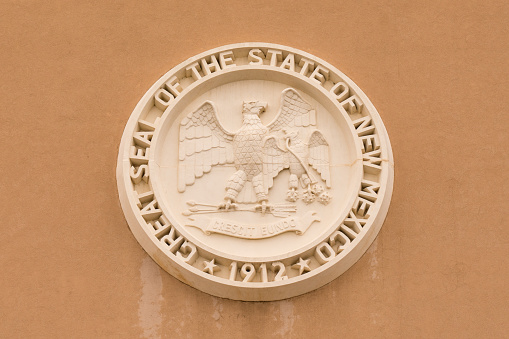 Santa Fe, New Mexico - October 4, 2019: State seal of New Mexico on the facade of the state capitol building