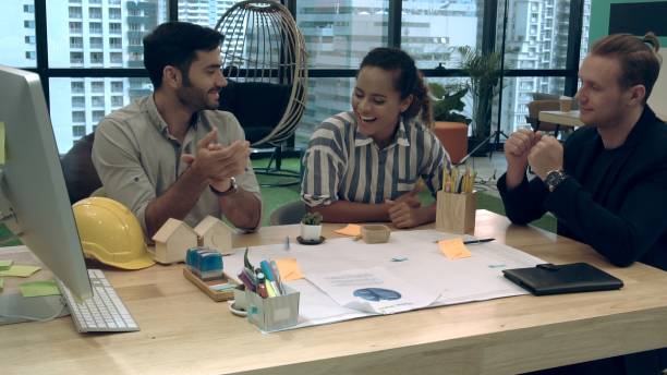 istock Creative business people group having conversation at office desk in workplace. 1190951898