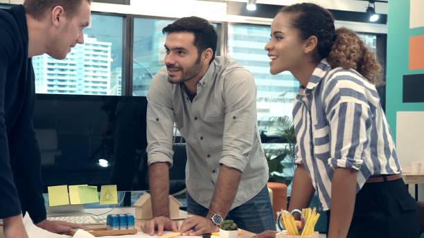 istock Creative business people group having conversation at office desk in workplace. 1190952006