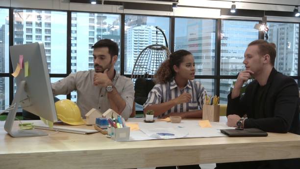 istock Creative business people group having conversation at office desk in workplace. 1190952036