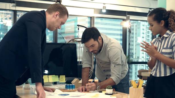 istock Creative business people group having conversation at office desk in workplace. 1190952071