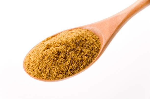 istock Cumin Powder in wooden spoon on White Background 1190955422