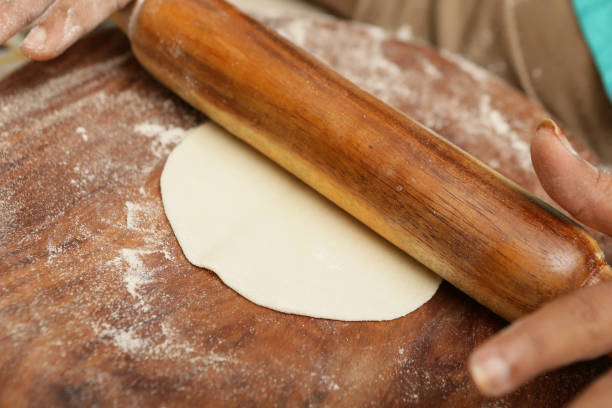 Rolling out dough to make traditional chapati