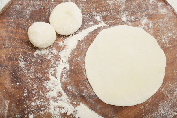 istock Rolling out dough to make traditional chapati 1190956383