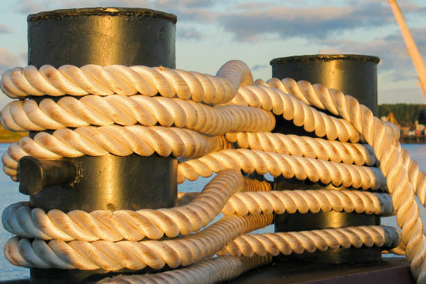 Mooring line on a bollard Mooring line on a bollard closeup mooring line stock pictures, royalty-free photos & images