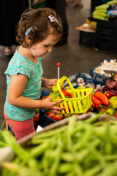 istock Kid shopping in vegetable market. 1190964745