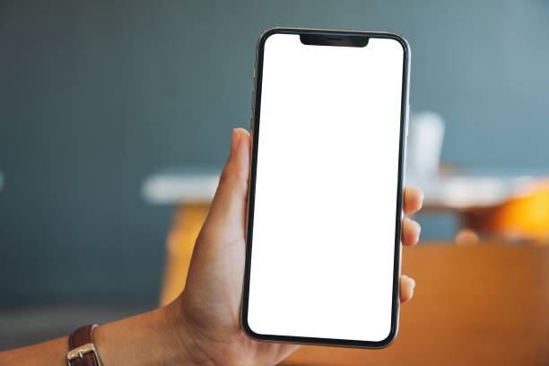istock a hand holding and showing black mobile phone with blank screen in cafe 1190965395
