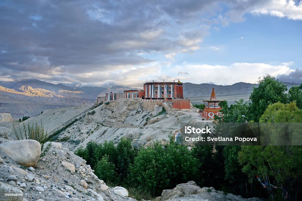 Tsarang Gompa rises on a hill - a monastery of the Sakya sect, built in 1395. Trekking to the Upper Mustang closed area. Nepal. Adventure Stock Photo