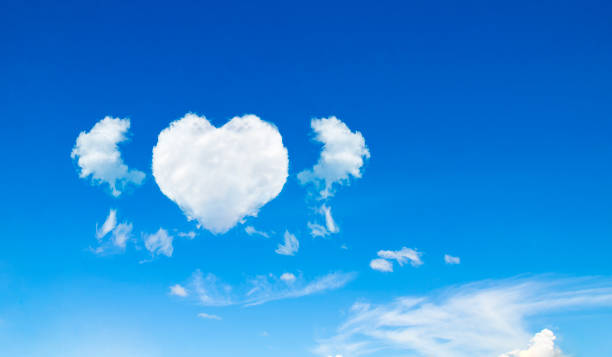 istock blue sky with heart shaped cloud in bright morning. 1190969111