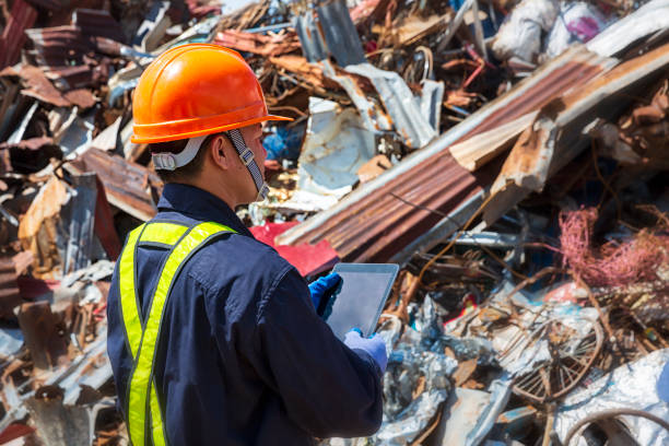 istock Engineer and Recyclable material. An engineer looking at recycling waste To proceed to the next process. Foreman wearing protective equipments and holding tablet and looking at Recyclable material. 1190970047