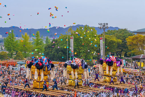 Niihama, Japan - October 17, 2019: View of the Niihama Taiko Festival scene, with taikodai drum floats, released balloons, participants and crowd, Ehime, Shikoku Island, Japan