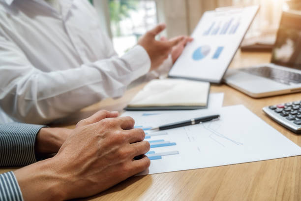 istock Business team brainstorming and discussing with financial data and report graph. Teamwork meeting working concept. 1190972954
