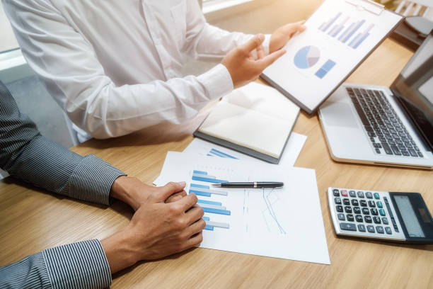 istock Business team brainstorming and discussing with financial data and report graph. Teamwork meeting working concept. 1190972971