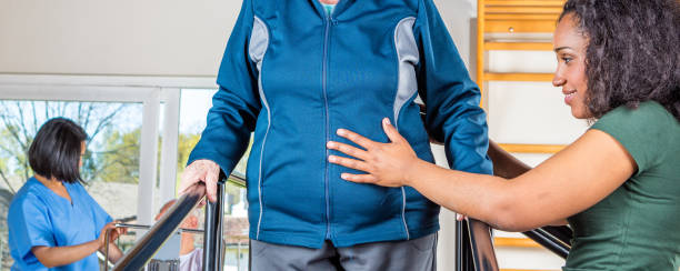 istock Senior citizens working out at a gym helped by multi race trainers 1190973810