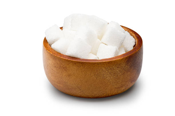 istock Cube granulated sugar in a wooden bowl on a white background with clipping path. 1190976309