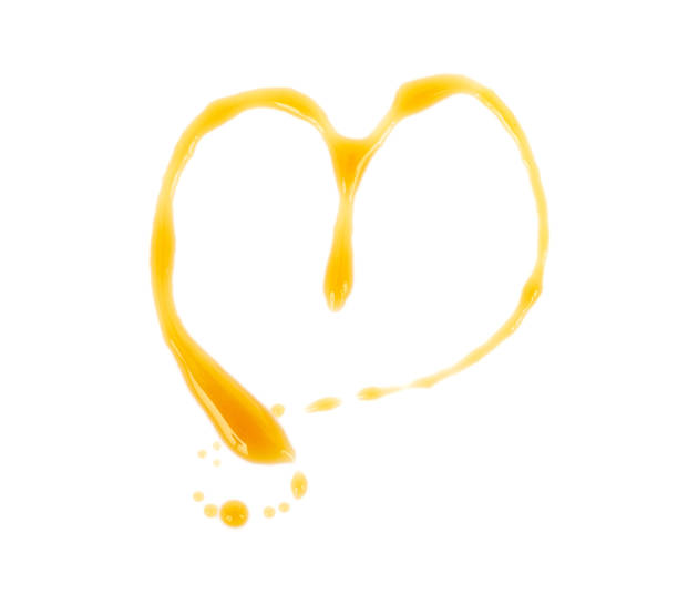 Heart shaped maple syrup isolated on white. Top view.