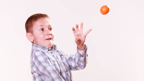 istock Young boy play with fruit 1190977386