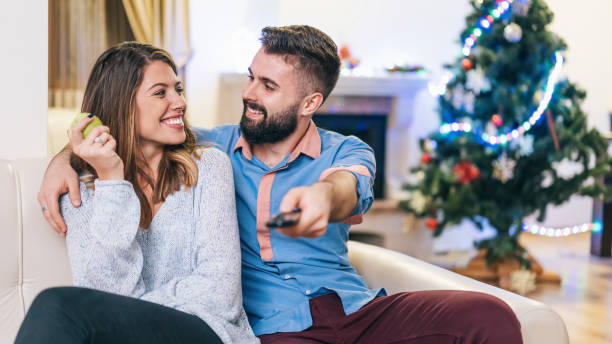 istock Happy couple watching TV at home 1190978729