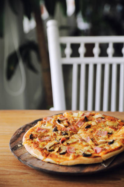 istock pizza ham and mushroom on wood background 1190978789