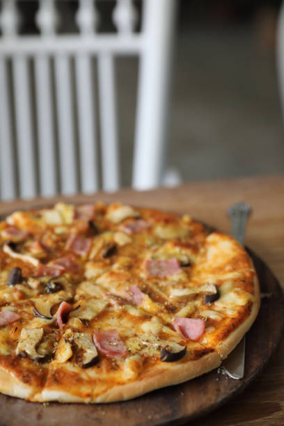 istock pizza ham and mushroom on wood background 1190978815