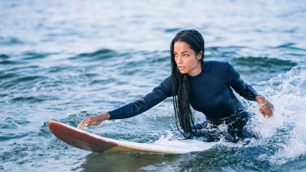 istock Asian female surfer in sea 1190979315