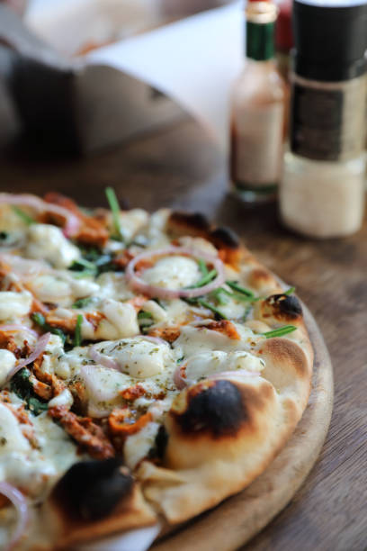 istock Tandoori Chicken Pizza on wooden table 1190981436
