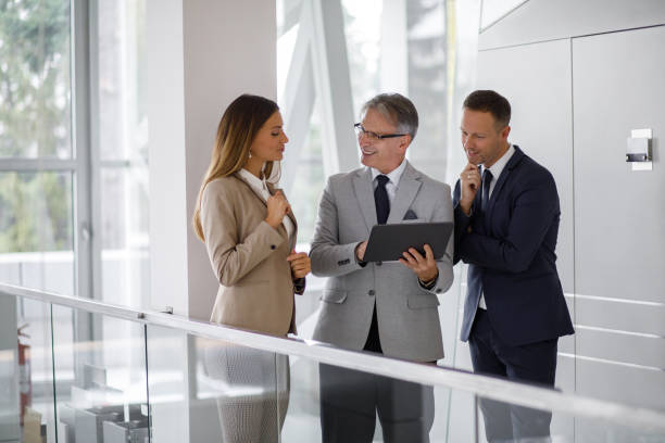 istock Group of mixed aged business people collaborating over digital tablet 1190983580