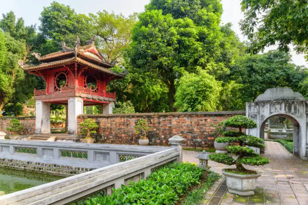 Awesome view of the Khue Van pavilion among green trees from the third courtyard of the Temple of Literature in Hanoi, Vietnam. The Temple of Confucius is a popular tourist destination of Asia.