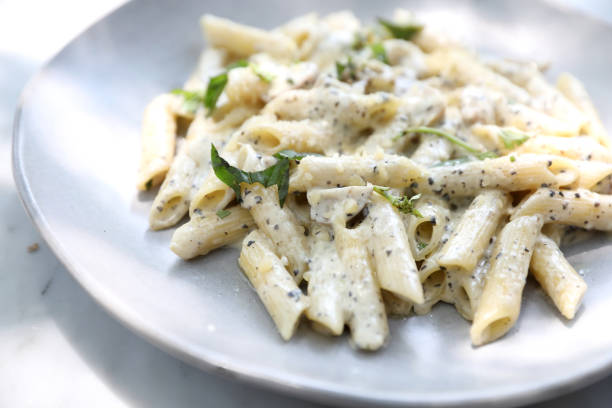 Penne pasta with white sauce and truffle , italian food Penne pasta with white sauce and truffle , italian food penne stock pictures, royalty-free photos & images