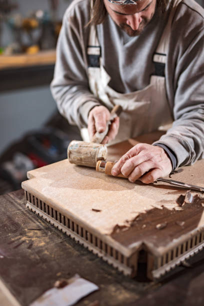 istock Carpenter working on a old wood in a retro vintage workshop. 1190992403