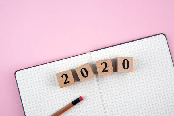 istock New Year 2020 notebook on pink background 1190992590