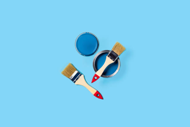 istock Blue background with paint jar and brushes. 1190995445