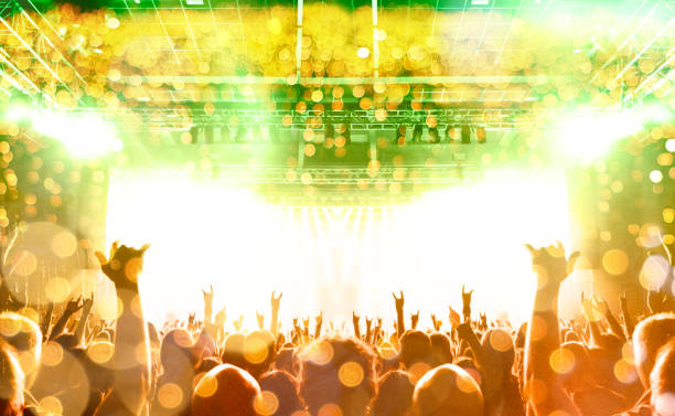 istock Concert stage, people are visible waving and clapping, silhouettes are visible 1190997138