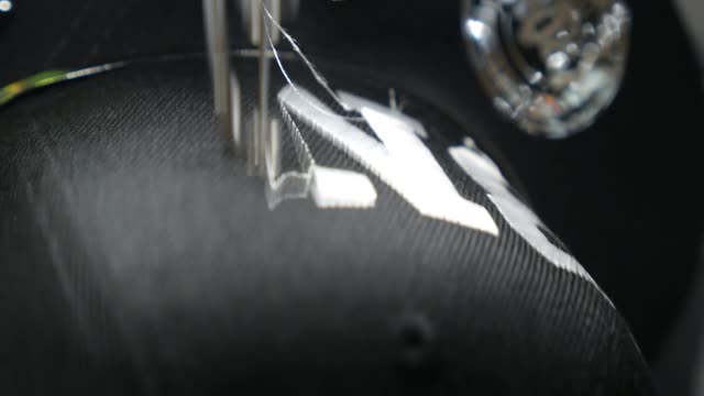 Automatic Sewing Machine Stitching Lettering On Cap. Closeup.