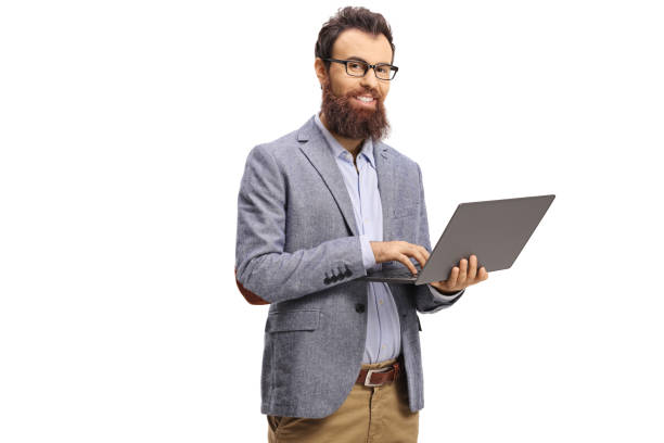 istock Bearded man holding a laptop computer and smiling at the camera 1191001737