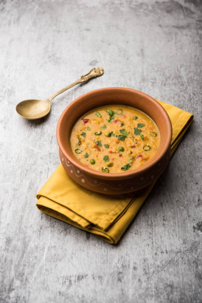 Vegetable masala oats khichadi served in a bowl. selective focus stock photo