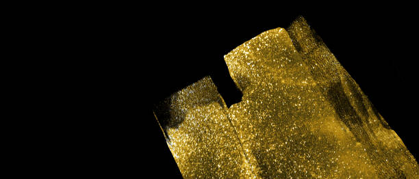 istock Banner with abstract gold shimmer strokes on black background 1191004442