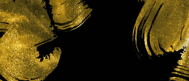 istock Banner with abstract gold shimmer strokes on black background 1191004445