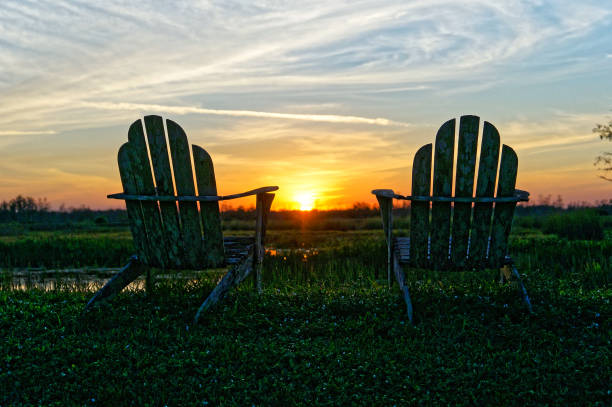 istock Louisiana sunset swamp and chairs 1191004739