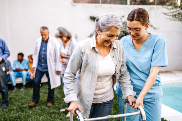 istock Nurse assisting senior woman with mobility walker 1191007114